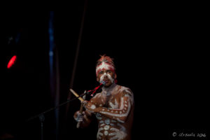 Indigenous Aboriginal man in white face paint, Arakwal Opening Ceremony, Byron Bay Bluesfest 2016