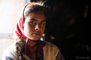 Young Rajasthani Woman in a dark Doorway, Thar Desert village, India