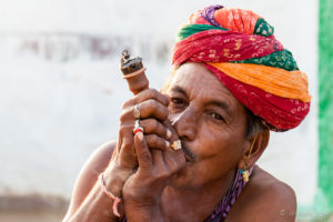 Rajasthani man in a turban with a pipe, Khiyasariya village, India
