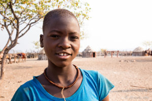 Himba School Girl with a shaved head, Otjomazeva Village, Kunene Namibia