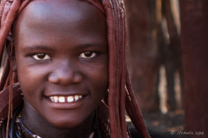 Portrait: Smiling young Himba woman, Otjomazeva Village, Kunene Namibia