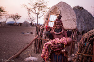 Young Himba woman with a baby, Otjomazeva Village, Kunene Namibia