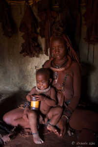Himba Mother and Child inside a hut, Otjomazeva Village, Kunene Namibia
