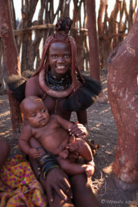 Young Himba woman with a baby, Otjomazeva Village, Kunene Namibia