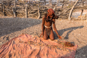 Female Himba teen in a forward-braided hairstyle with Trinkets, Otjomazeva Village, Kunene Namibia