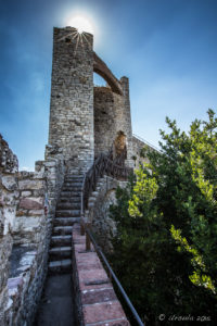 Sun flare on a Castello del Leone tower, Italy