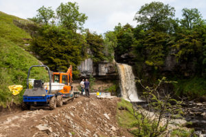 Road-work equipment in front of Thornton Force, Ingleton Waterfalls Trail, North Yorkshire, UK