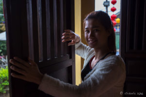 Young Vietnamese woman indie side-light, Nguyen Tuong Family Temple, Hoi An, Vietnam