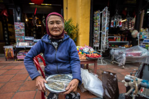 Old Vietnamese woman in a pink knit hat with Betel Juice out, Hoi An Vietnam