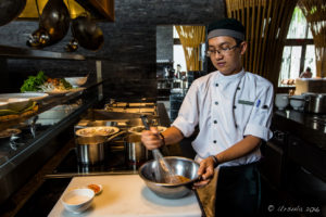 Vietnamese man in chef uniform whisking sauce, Hay Hay Restaurant Display Kitchen, Naman Retreat Danang Vietnam