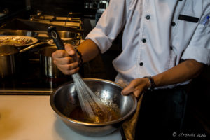 Man in white uniform whisking sauce, Hay Hay Restaurant Display Kitchen, Naman Retreat Danang Vietnam