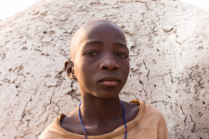 Young Himba Male with a shaved head, Kunene Region, Namibia