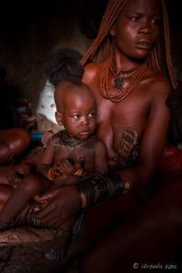 Himba Mother and Child in a dark hut, Kunene Region Namibia