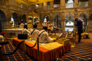 Three Sikh musicians on a platform, Gurudwara Sis Ganj Sahib, Delhi