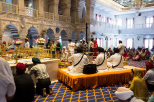 Three Sikh musicians on a platform, Gurudwara Sis Ganj Sahib, Delhi