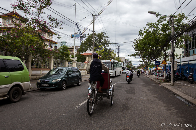 Pedicab and traffic on Le Duan Street, Danang Vietnam.