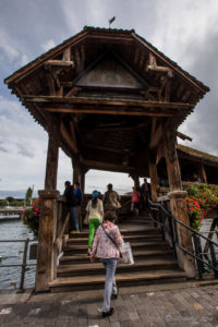 Tourists walking the steps up to the Chapel Bridge - Kapellbrücke, Lucerne Switzerland