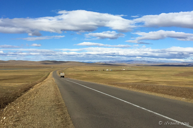 View through a UAZ windscreen: a long Mongolian Roadway