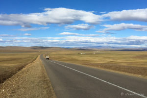 View through a UAZ windscreen: a long Mongolian Roadway