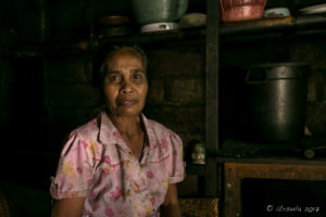 Portrait of a Balinese woman in her very dark kitchen, Gianyar