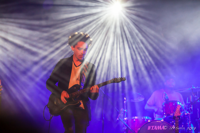 Guitarist Ian Neville under bright stage lights, Bluesfest 2017 Byron Bay AU