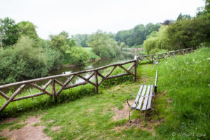 A empty bench, The Weir riverside garden, Herefordshire, UK
