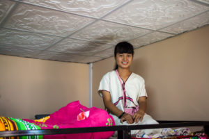 Karen school girl on a top bunk, Santisuk School, Chiang Mai Thailand