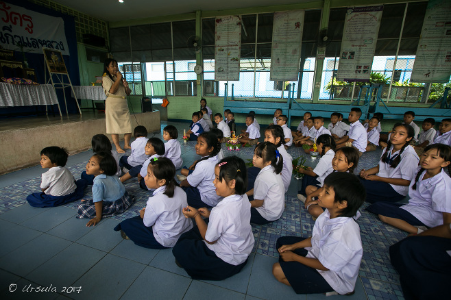 Thai school children sitting on a school auditorium floor, Chiang Mai Thailand 