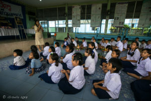 Thai school children sitting on a school auditorium floor, Chiang Mai Thailand