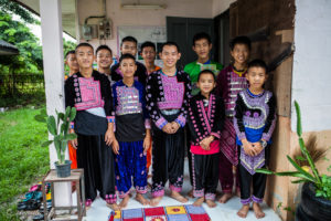 Hmong boys in traditional costume outside their Dormitory, Santisuk School, Chiang Mai Thailand