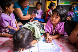 Thai girls on the floor of a Classroom, Mae Sariang, Thailand