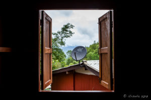 View of TV Receiver on a building, outside a shuttered WIndow, Mae Sariang, Thailand