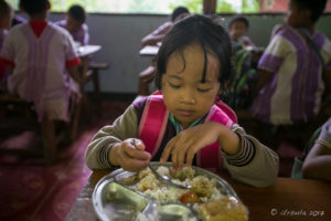 Karen schoolgirl eating Lunch, Mae Sariang Thailand