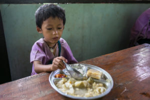 Karen schoolgirl eating Lunch, Mae Sariang Thailand