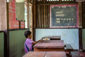 Karen schoolgirl clearing her Lunch plate, Mae Sariang Thailand