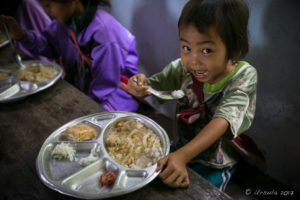 Karen schoolgirl eating Lunch, Mae Sariang Thailand