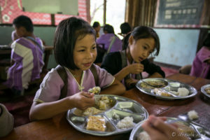 Karen schoolgirl eating Lunch, Mae Sariang Thailand
