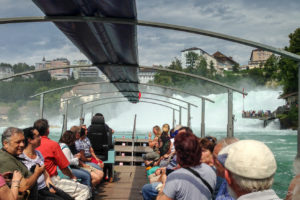 Tourists in a boat on the Rheinfall, Switzerland