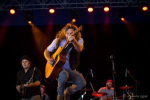 Chris Eaton leaping with his guitar, Round Mountain Girls, Byron Bay Bluesfest 2017, Australia