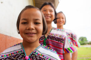 Portrait: Three Karen school children in traditional clothing, Mae Hong Son, Thailand.