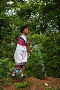 Karen girl with a Water hose, Ban Mae Pae, Mae Hong Son Thailand