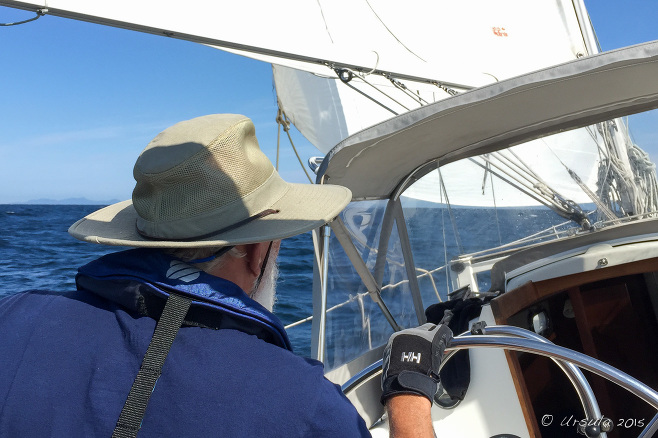 Man in a hat helming a Saiboat, Strait of Georgia BC