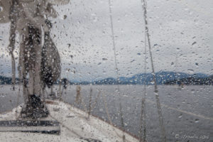 Rain on the cockpit enclosure of a sailboat, Strait of Georgia, BC Canada