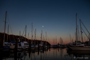 Moonrise over the boat masts of Stones Marina, Nanaimo, BC Canada