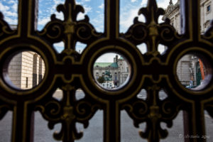 Statue of Prince Eugene of Savoy seen through an ornate fence, Vienna
