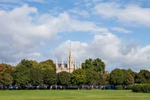 Vienna City Hall Clock Tower behind green trees, Austria