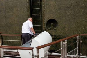 A river-boat captain Guiding a Boat out of Altenwörth Lock on the Danube, Austria