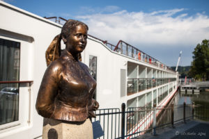 Statue of writer Emerenz Meier and River-cruise boats, Danube, Passau