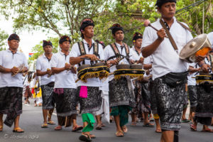 Balinese men in procession with musical instruments, Ubud