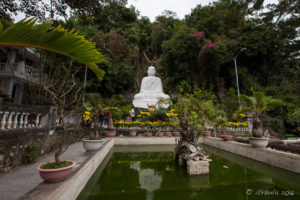 White marble Buddha over a reflecting pond, Marble Mountain, Non Nuoc Village, Vietnam